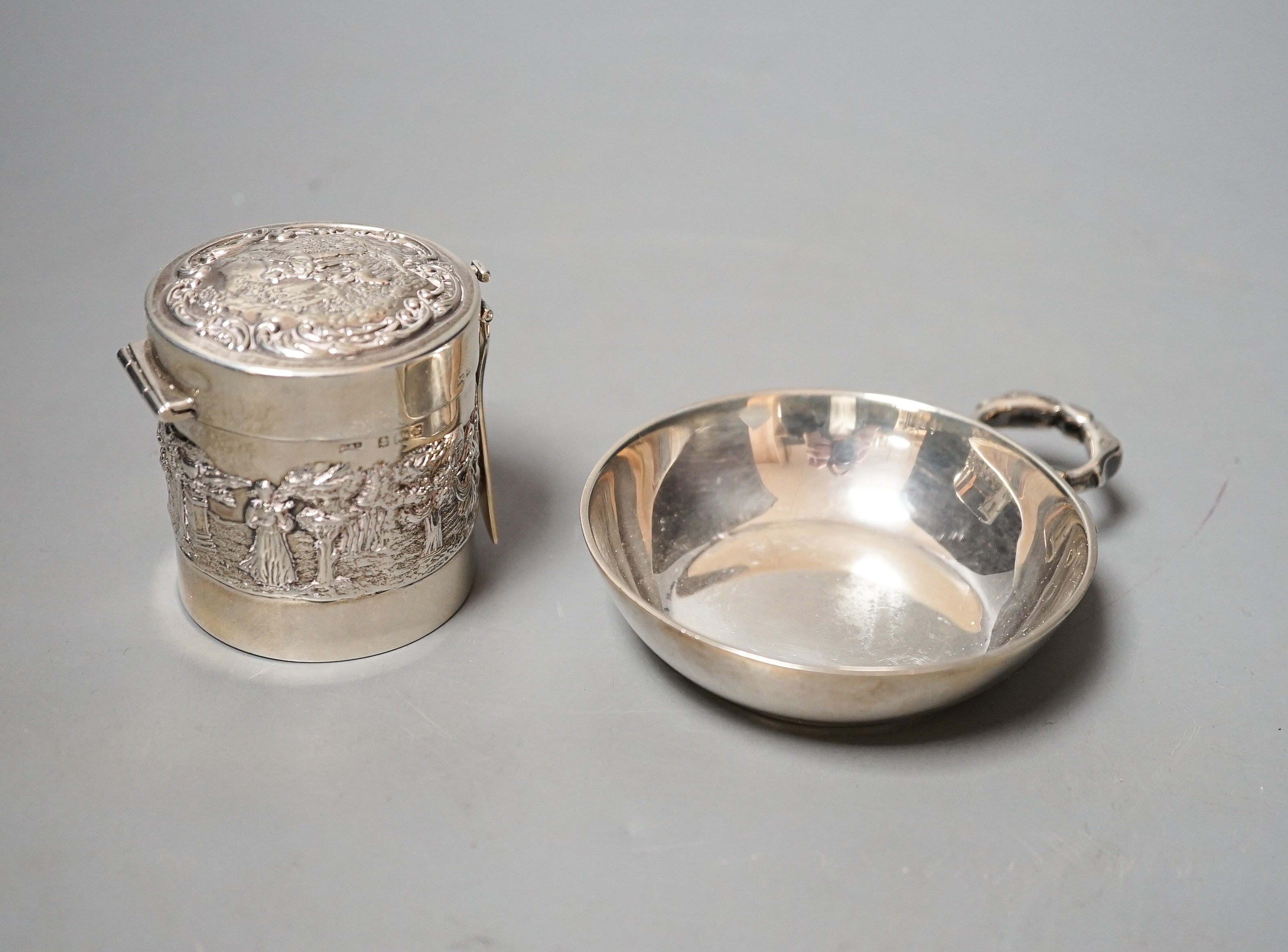 A George V silver taste vin, Tessiers Ltd, London, 1924, 10.2cm, together with an Edwardian embossed silver travelling hair curling tongs warmer, Levy & Salaman, Birmingham, 1901, 52mm (lacking warmer?).